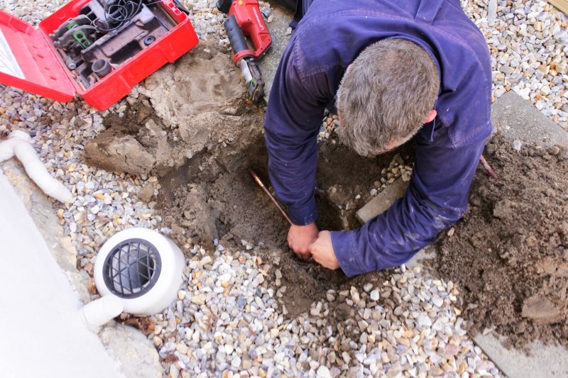 Plumber Working on a Pipe